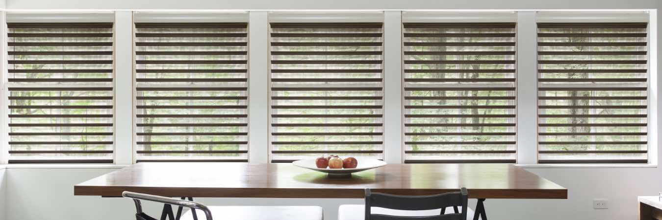 Chocolate brown blinds on a row of windows in a dining area