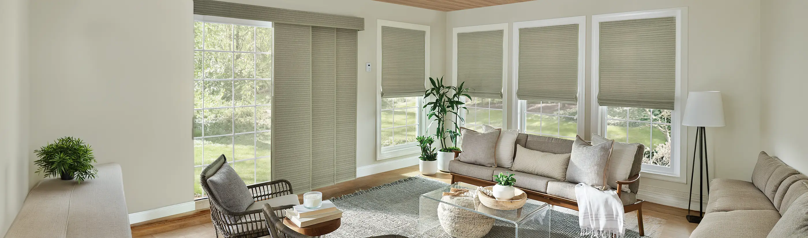 sage green woven shades on windows and a patio door in a living room