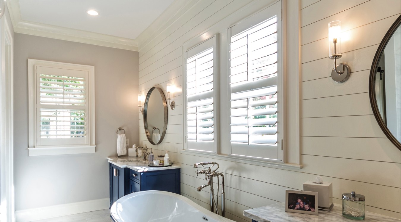 Charlotte bathroom with white plantation shutters.