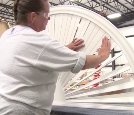 Woman working on building a customer shutter