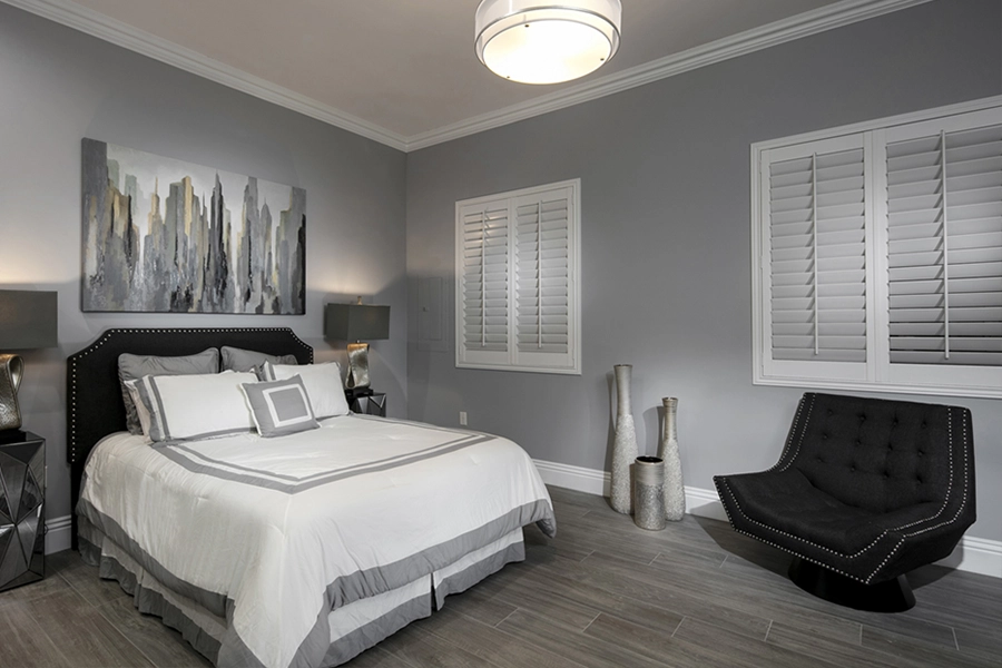 Close your custom Polywood shutters to beat the heat and keep your Charlotte bedroom cool. White Polywood shutters on bedroom windows