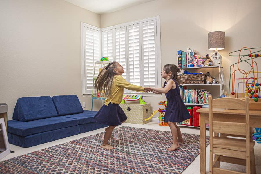 Choose Polywood shutters for durable, kid-friendly great room window treatments in Charlotte. Polywood shutters on multiple windows in a sitting area