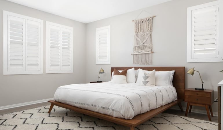 Open shutter louvers will help any Charlotte room feel larger. Plantation shutters in a model home bedroom.