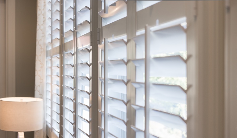 East-West windows have problems with glare during sunrises and sunsets. Plantation shutters close up