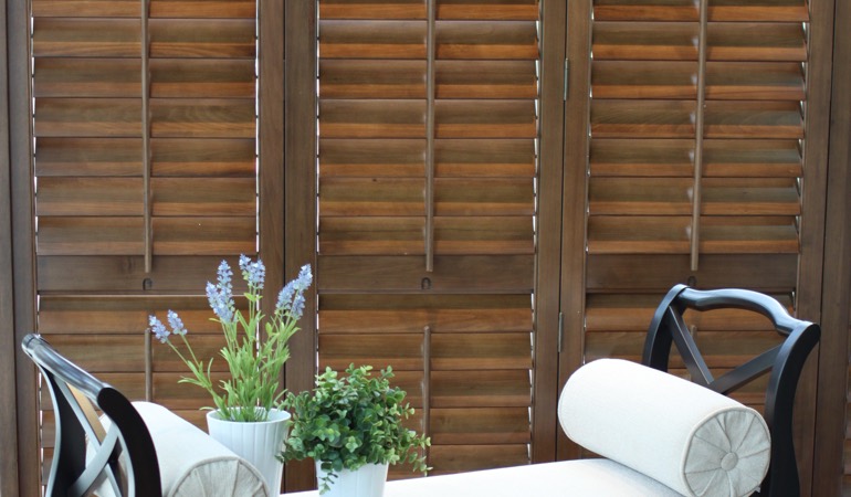 Hardwood shutters can blend in with many home design schemes. Hardwood plantation shutters in a nook