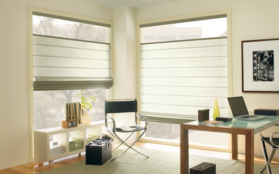 Upgrade your windows with stylish window shades or shutters in Charlotte. Stylish sheer shades in the corner of a modern office.