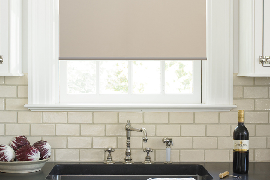 Roller shades opens up a lot of color and style options for your gourmet kitchen at Charlotte. Roller shade above a kitchen sink.