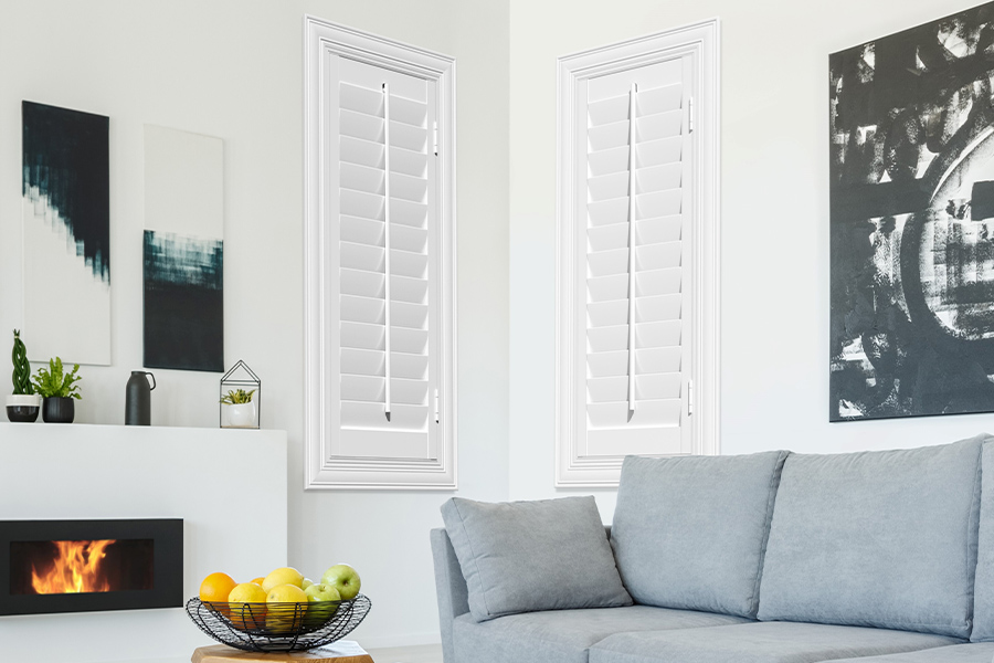 White Polywood shutters add character and class in Charlotte. White polywood shutters in a corner of a modern living room.
