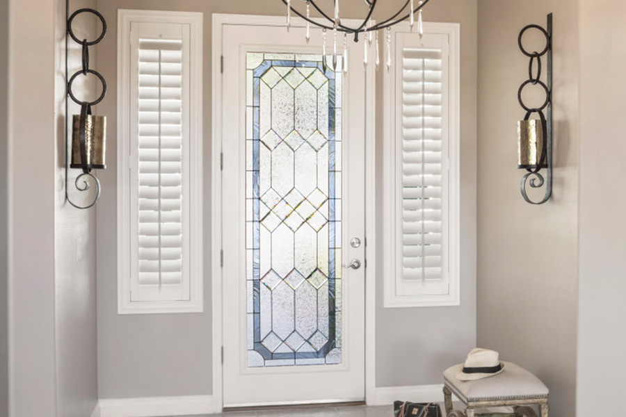 Polywood shutters offer flexibility on the brightness of natural light in Charlotte. Sidelight windows with white polywood shutters in a foyer.