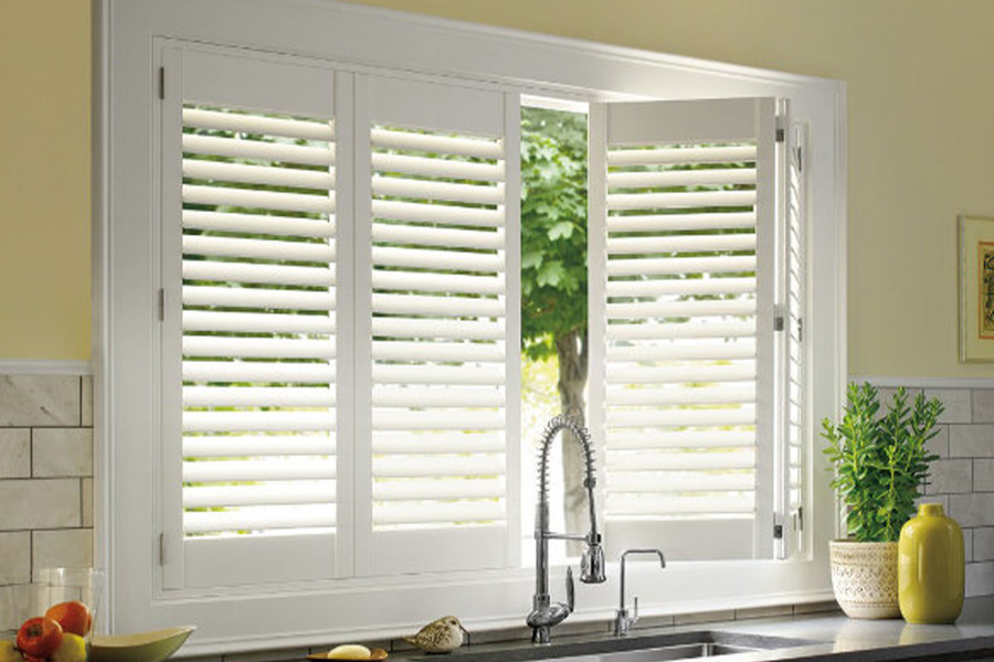 Polywood shutters are built to withstand the test of time in Charlotte. White Polywood shutters above a kitchen sink.